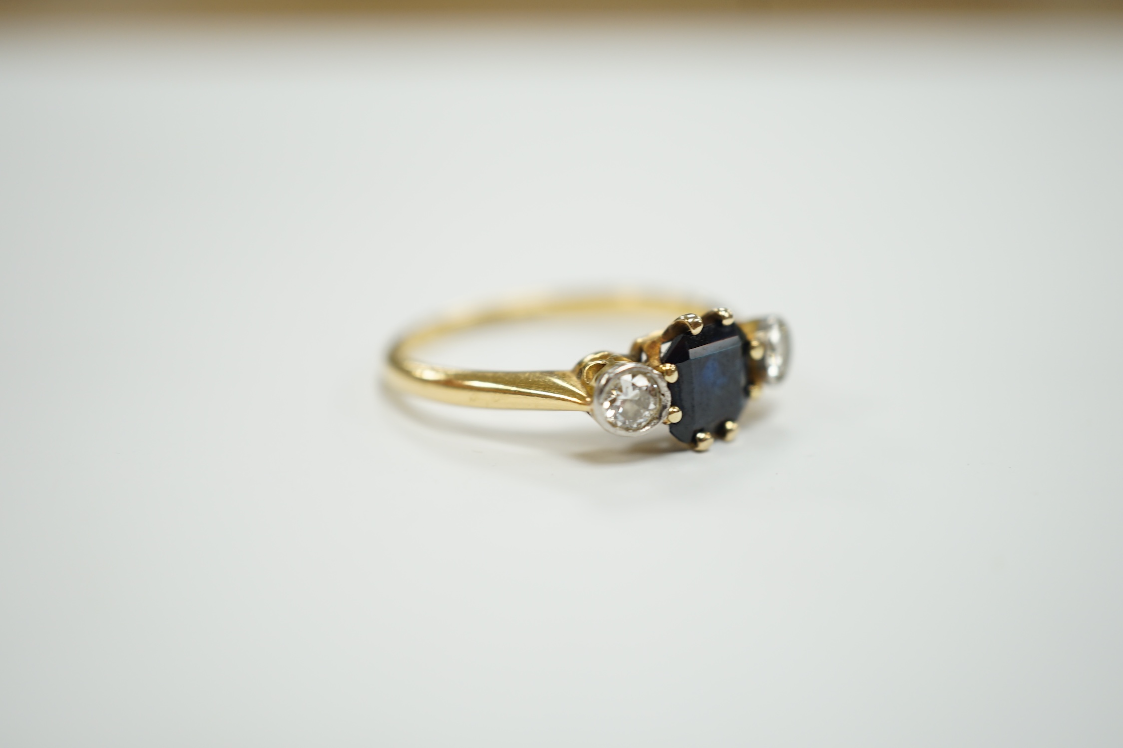 An 18ct and plat, single stone sapphire and two stone diamond set ring, size O/P, gross weight 3.1 grams.